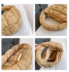 Detail view of khaki pleated cloud bag showing quilted texture, zipper and inner lining