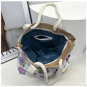 Detail view of linen tote bag interior with pineapple print and sturdy rope handle