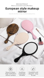 Detail of vintage embossed makeup mirror with elegant floral handle in classic retro style