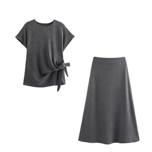 Flat lay of soft dark gray knit set with knotted short sleeve top and long A-line skirt