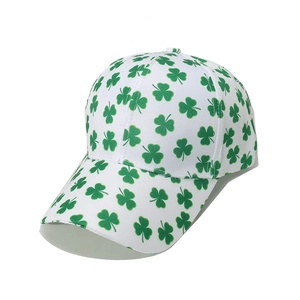 Detail of white cotton baseball cap featuring green clover leaf pattern embroidery