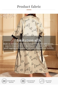 Rear view of champagne silk satin robe with black love print and contrast trim