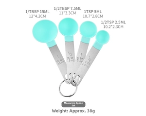 Set of four measuring spoons with stainless steel handles and mint green heads for baking