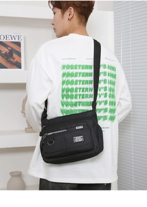 Close-up of durable black multi-layer crossbody bag featuring high-quality zippers