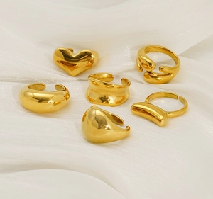 Detailed view of 18K gold plated stainless steel rings on elegant white silk fabric