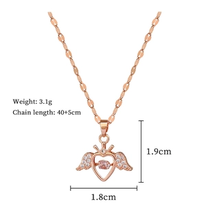 Macro detail of angel wing heart pendant with pink stone and dimensions shown