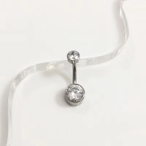 Close-up of G23 titanium belly button ring with two round clear cubic zirconia stones