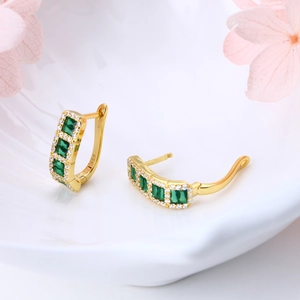 Macro shot of S925 sterling silver hoop earrings with green zircon stones