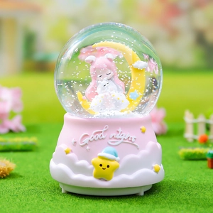 Detailed view of pink moonlight crystal ball music box with cartoon girl on moon and snow effect