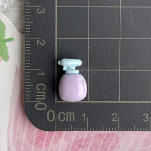 Detailed macro view showing the 1.5cm miniature purple spray bottle resin accessory
