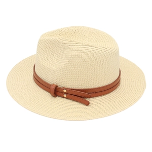 Close-up of Panama straw hat with a brown leather band and gold rivet detail