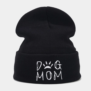 Close-up of white Dog Mom embroidery with paw print on black ribbed knit beanie hat