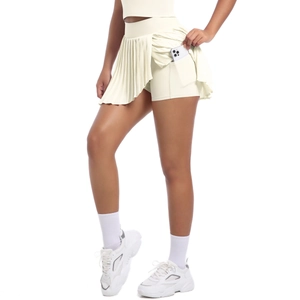 Detail showing inner lining pocket and pleated fabric of the beige tennis skirt