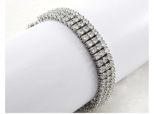 Macro shot of silver-tone stainless steel four-row tennis bracelet with clear zircon stones