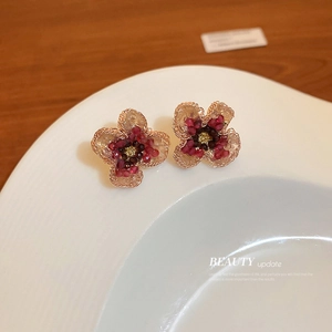 Handmade flower earrings with gold wire and pink red crystals in a stylish design