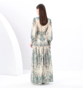 Back view of a long paisley print dress with vintage stand collar and lantern sleeves