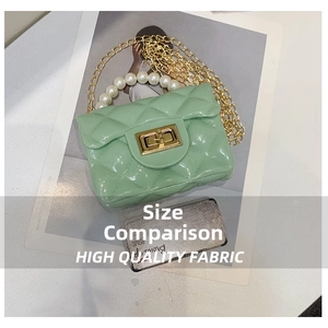 Detail of mint green jelly bag with quilted pattern, pearl handle and gold chain