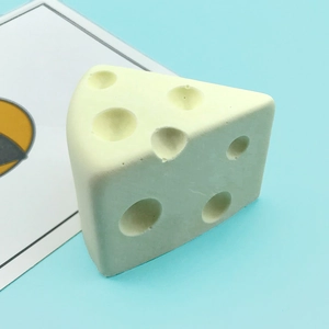 Cheese shaped silicone mousse mold with realistic pore details on a blue background