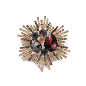 Vintage gold sunburst brooch with colorful crystals and burgundy drop stone