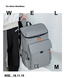 Close-up of minimalist gray waterproof backpack featuring vibrant orange zipper pulls