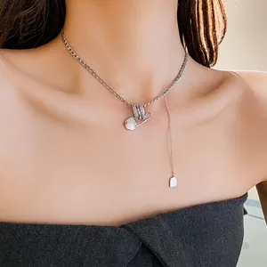 Silver paperclip necklace with zircon rings and pendant on model for fashion style