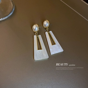 Exaggerated geometric earrings with gold metal, pearls and white acrylic trapezoid pendants