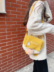 Cute lamb wool yellow duck crossbody plush bag with rabbit brooch shown on model