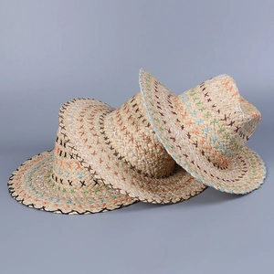 Close-up of woven straw hat featuring colorful cross-stitch details and black edges