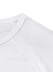 Detail of waffle knit fabric and raglan sleeve stitching on white men's henley shirt
