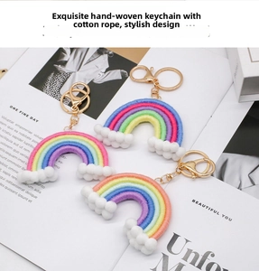 Detail of three handmade macrame rainbow keychains with cotton rope and soft cloud pom poms