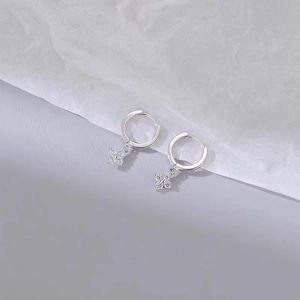 Elegant S925 silver flower earrings with zircon pendants on a minimalist background