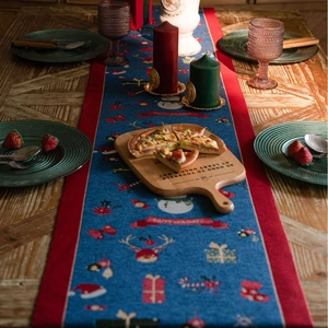 Blue Christmas jacquard table runner with festive snowman and reindeer patterns
