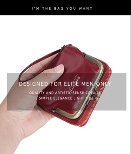 Close-up of dark red lychee texture leather coin purse with vintage bronze clasp and strap