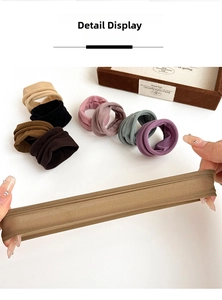 Macro detail of wide ribbed hair ties showing high elasticity and soft texture