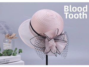Detail of pink summer hat with a large organza flower and delicate mesh decoration