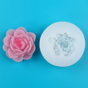 Detailed peony silicone mold with finished pink petal candle and golden glitter decoration
