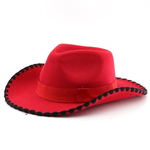 Close-up of red wool felt cowboy hat featuring black whipstitch brim and grosgrain ribbon