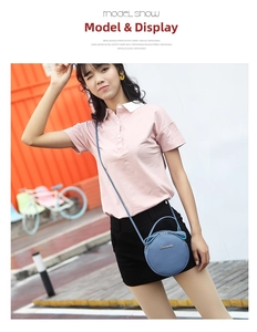 Close-up of blue leather round crossbody bag with golden logo and litchi texture finish