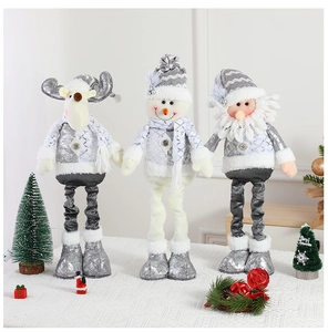 Detail of three telescopic Christmas plush dolls in silver and grey with sequin fabric texture