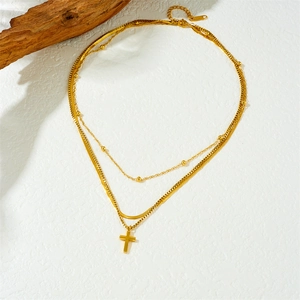 Layered gold-plated stainless steel necklace with cross pendant and flat snake chain