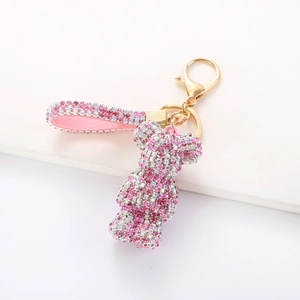 Detail of pink rhinestone bear keychain with glittering gradient crystals and golden clasp
