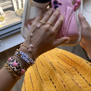 Colorful layered bracelet set with gold chains, butterfly hand chain and letter beads