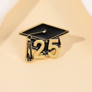Detail of a black graduation cap brooch with gold 2025 numbering and metallic finish