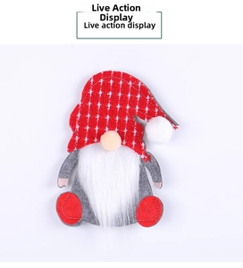 Detail of Christmas gnome cutlery holder with red plaid hat and grey felt body