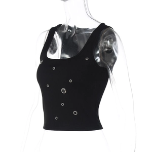 Close-up of black ribbed tank top featuring decorative silver metal eyelets on fabric