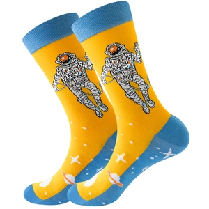 Detail of yellow crew sock with blue accents featuring astronaut and planet space patterns