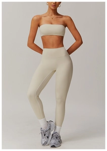 Close-up of high-waisted ribbed yoga leggings and sports bra set in beige minimalist style