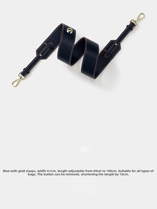 Detail of adjustable 4.1cm wide dark blue pebble leather shoulder strap with gold hardware