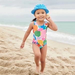 Girl's colorful abstract print swimsuit set with a wide-brim sun hat for beach fun