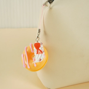 Llavero de rosquilla realista de 4,5 cm con fresa y perlas decorativas en un bolso beige